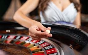 Live Andar Bahar dealer at angka sgp studio, camera angle showing card table and pit manager